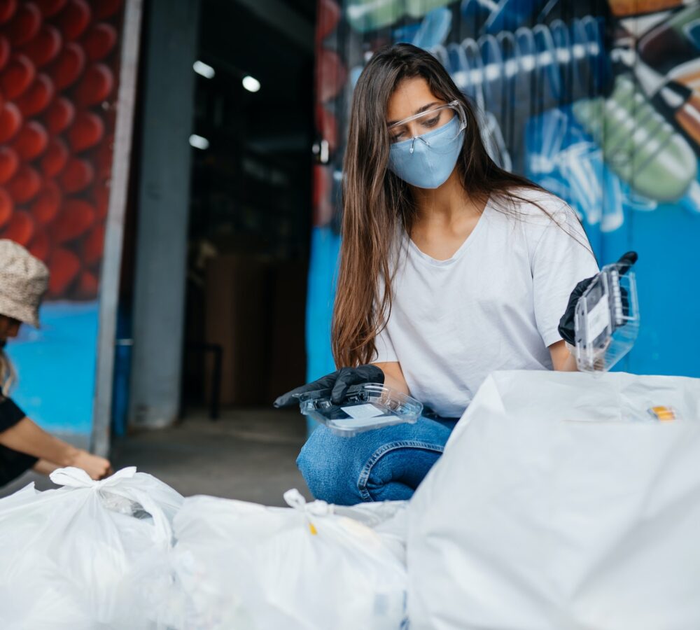 young woman sorting garbage concept of recycling zero waste
